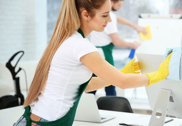Young female worker cleaning office